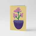 A6 Greetings Card Vertical - Modern illustration of pink geometric flowers in a deep purple pot against a bright yellow background